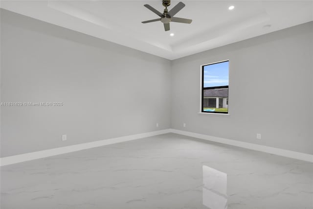 2505 40th, Lehigh Acres, FL 33976 - empty room featuring a tray ceiling, recessed lighting, marble finish flooring, and ceiling fan
