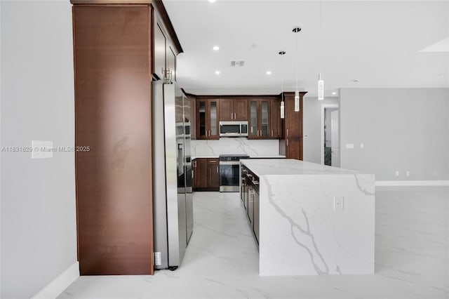 2505 40th, Lehigh Acres, FL 33976 - kitchen with appliances with stainless steel finishes, light marble finish floors, a center island, glass insert cabinets, and decorative light fixtures