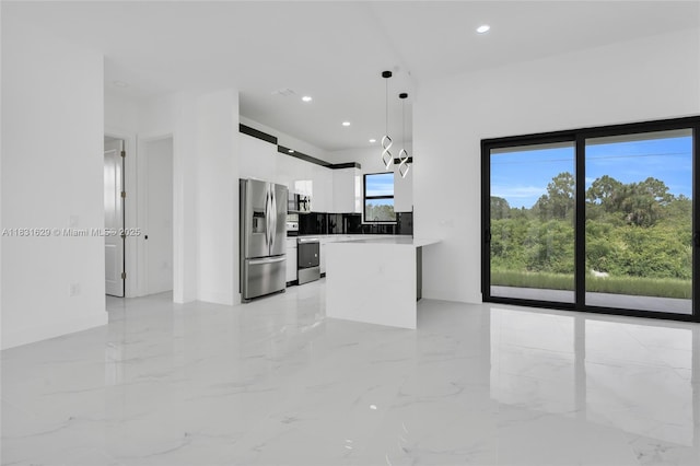 2505 40th, Lehigh Acres, FL 33976 - kitchen with appliances with stainless steel finishes, white cabinets, modern cabinets, a peninsula, and hanging light fixtures