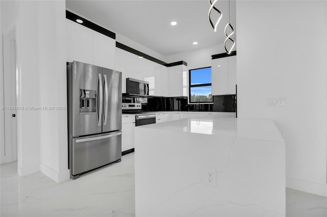 2505 40th, Lehigh Acres, FL 33976 - kitchen featuring stainless steel appliances, modern cabinets, white cabinetry, light marble finish floors, and tasteful backsplash