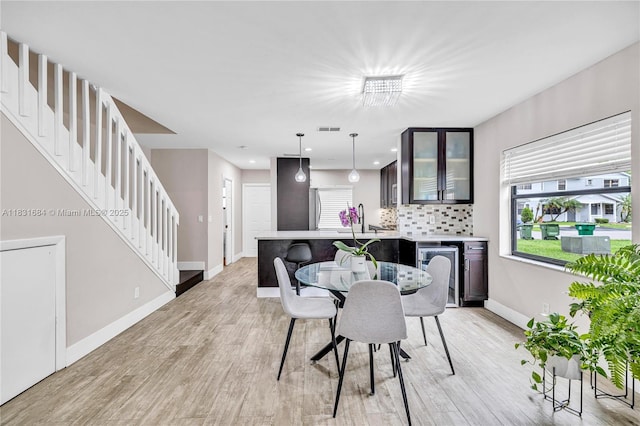 10527 NW 6th St, Pembroke Pines, FL 33026 - dining area with stairs, light wood-style flooring, beverage cooler, and recessed lighting