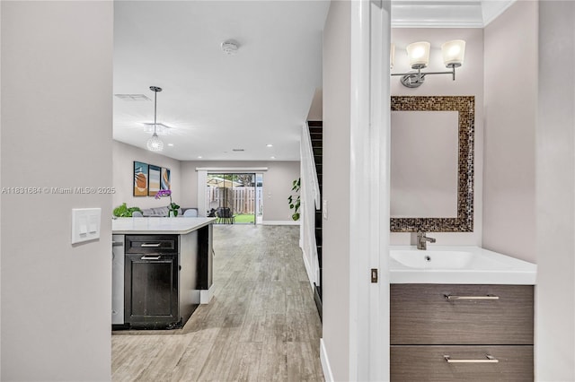 10527 NW 6th St, Pembroke Pines, FL 33026 - kitchen with light wood-type flooring, light countertops, open floor plan, and hanging light fixtures