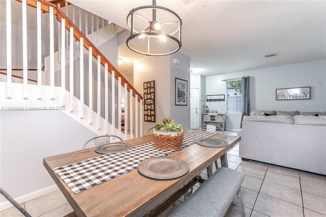 18481 NW 22nd St, Pembroke Pines, FL 33029 - dining area with stairs, light tile patterned floors, a textured ceiling, and a chandelier