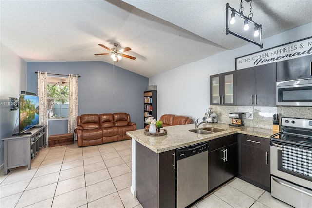 18481 NW 22nd St, Pembroke Pines, FL 33029 - kitchen featuring stainless steel appliances, a peninsula, light tile patterned floors, ceiling fan, and decorative backsplash