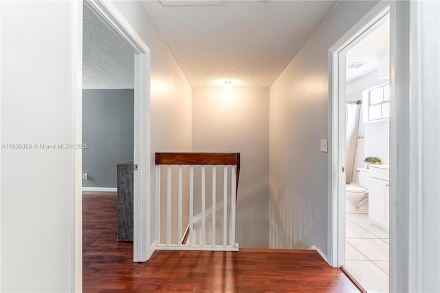 18481 NW 22nd St, Pembroke Pines, FL 33029 - hallway with wood finished floors, an upstairs landing, and a textured ceiling