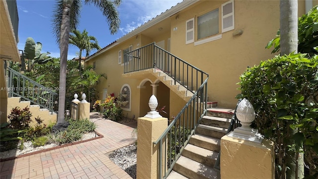 1145 Lake Shore Dr Unit 205, Lake Park, FL 33403 - exterior space featuring stairway and stucco siding