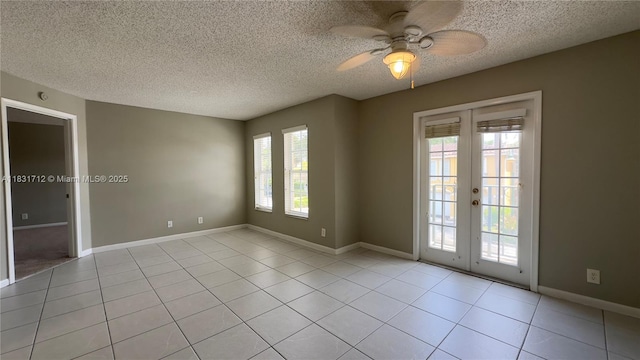1145 Lake Shore Dr Unit 205, Lake Park, FL 33403 - spare room with plenty of natural light, ceiling fan, french doors, a textured ceiling, and light tile patterned floors