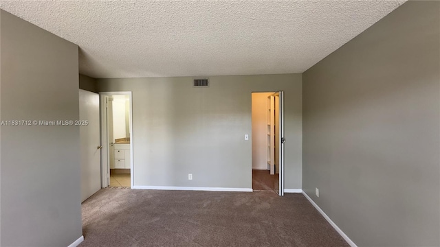 1145 Lake Shore Dr Unit 205, Lake Park, FL 33403 - unfurnished bedroom with carpet flooring, a textured ceiling, and ensuite bath