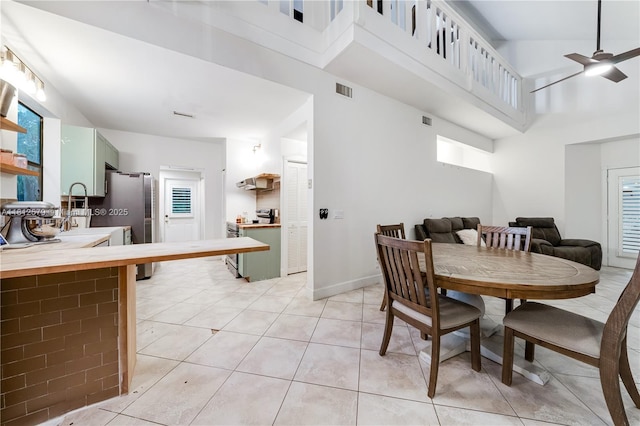 7900 SW Springhaven Ave, Indian Town, FL 34956 - dining room with a ceiling fan, a towering ceiling, and light tile patterned floors