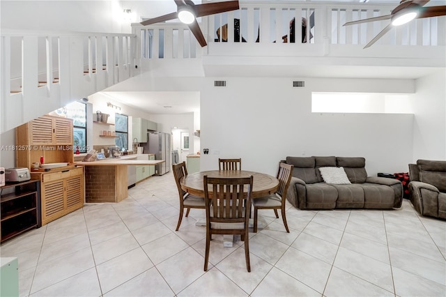 7900 SW Springhaven Ave, Indian Town, FL 34956 - dining space featuring a ceiling fan, light tile patterned floors, and a towering ceiling
