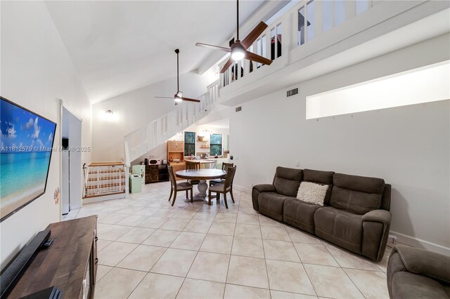 7900 SW Springhaven Ave, Indian Town, FL 34956 - living area with high vaulted ceiling, ceiling fan, stairway, and light tile patterned floors