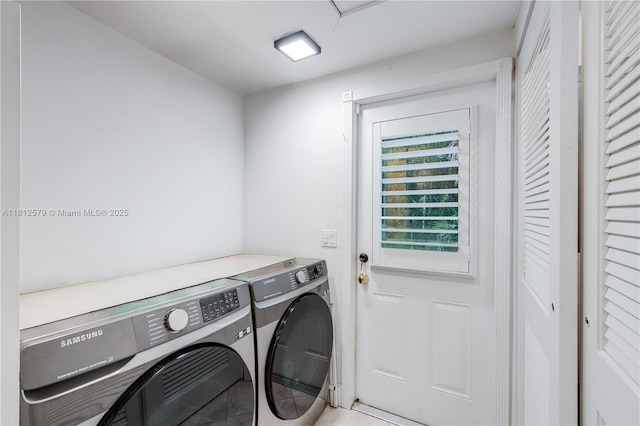 7900 SW Springhaven Ave, Indian Town, FL 34956 - washroom with washing machine and dryer and light tile patterned flooring