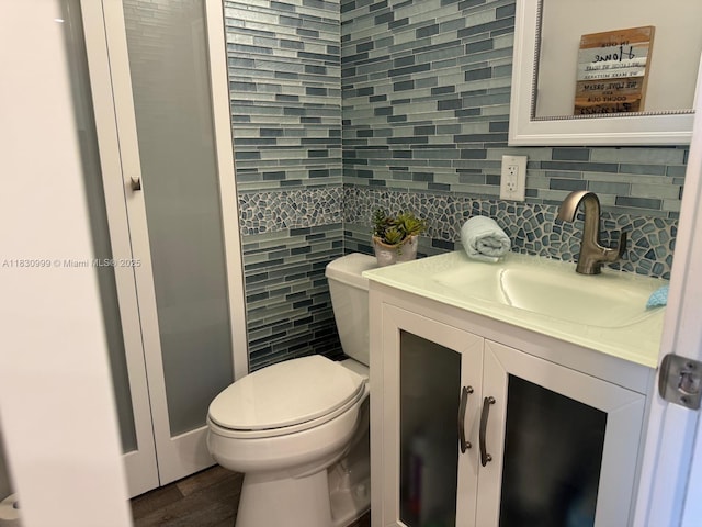400 N Surf Rd Unit 804, Hollywood, FL 33019 - bathroom featuring vanity, decorative backsplash, wood finished floors, and tile walls