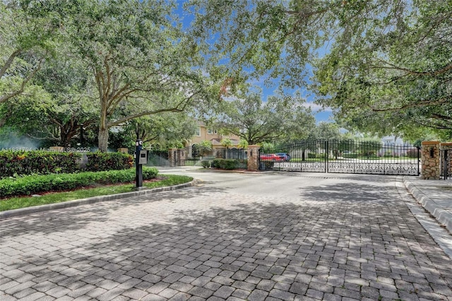 11056 Blackhawk Blvd, Davie, FL 33328 - view of road featuring a gate, curbs, and a gated entry