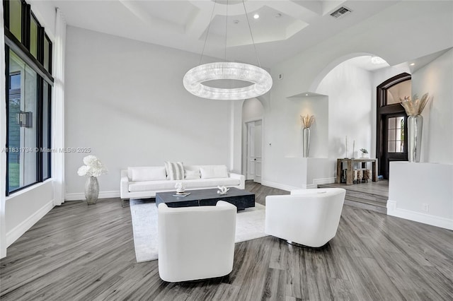 11056 Blackhawk Blvd, Davie, FL 33328 - living area featuring arched walkways, a high ceiling, wood finished floors, and recessed lighting