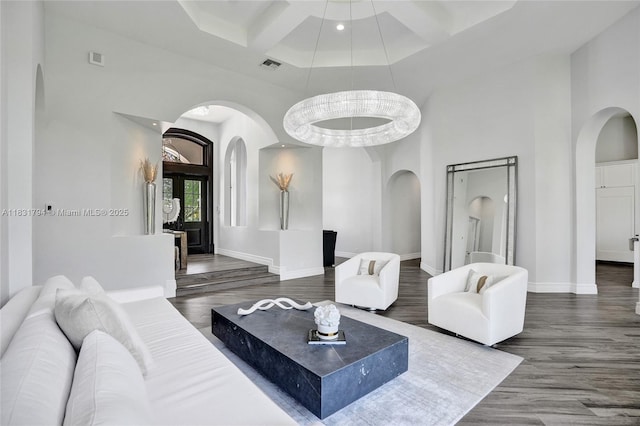 11056 Blackhawk Blvd, Davie, FL 33328 - living room with arched walkways, a high ceiling, coffered ceiling, wood finished floors, and beamed ceiling
