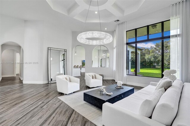 11056 Blackhawk Blvd, Davie, FL 33328 - living room featuring arched walkways, a towering ceiling, coffered ceiling, wood finished floors, and beamed ceiling