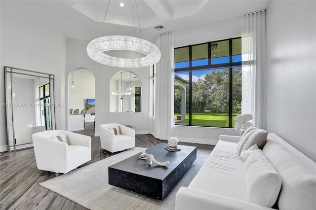 11056 Blackhawk Blvd, Davie, FL 33328 - living area with a high ceiling, wood finished floors, arched walkways, and a chandelier