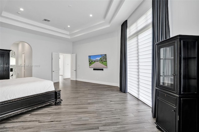 11056 Blackhawk Blvd, Davie, FL 33328 - bedroom with a tray ceiling, arched walkways, wood finished floors, multiple windows, and recessed lighting