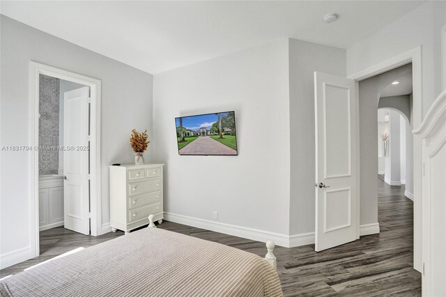 11056 Blackhawk Blvd, Davie, FL 33328 - bedroom with arched walkways, wood finished floors, and ensuite bath