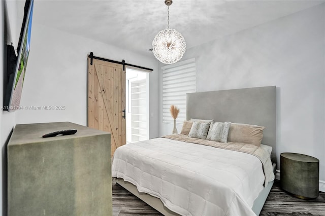11056 Blackhawk Blvd, Davie, FL 33328 - bedroom featuring a barn door, a chandelier, and wood finished floors