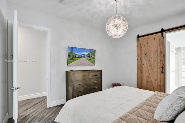 11056 Blackhawk Blvd, Davie, FL 33328 - bedroom with wood finished floors, a chandelier, and a barn door
