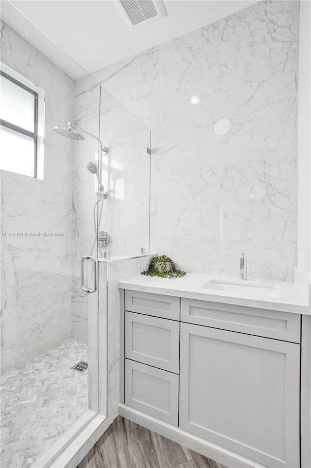 11056 Blackhawk Blvd, Davie, FL 33328 - bathroom with a marble finish shower, vanity, and wood finished floors
