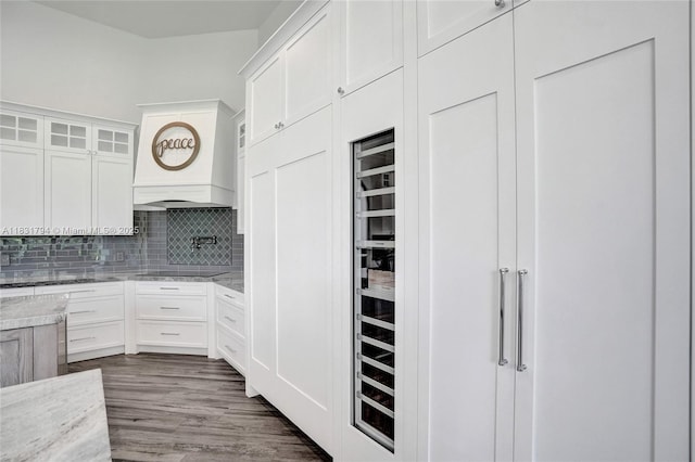 11056 Blackhawk Blvd, Davie, FL 33328 - kitchen featuring decorative backsplash, custom range hood, white cabinetry, and light stone countertops