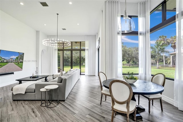 11056 Blackhawk Blvd, Davie, FL 33328 - living room featuring wood finished floors, a chandelier, and recessed lighting