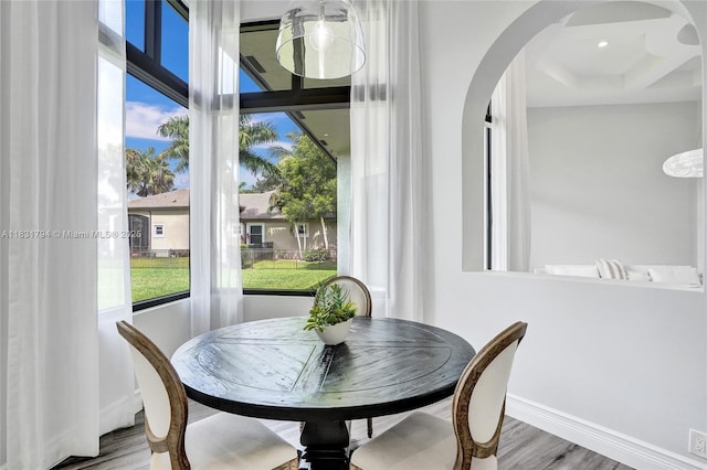 11056 Blackhawk Blvd, Davie, FL 33328 - dining space with wood finished floors, arched walkways, and healthy amount of natural light