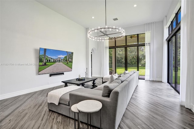 11056 Blackhawk Blvd, Davie, FL 33328 - living area with a chandelier, wood finished floors, recessed lighting, and a high ceiling