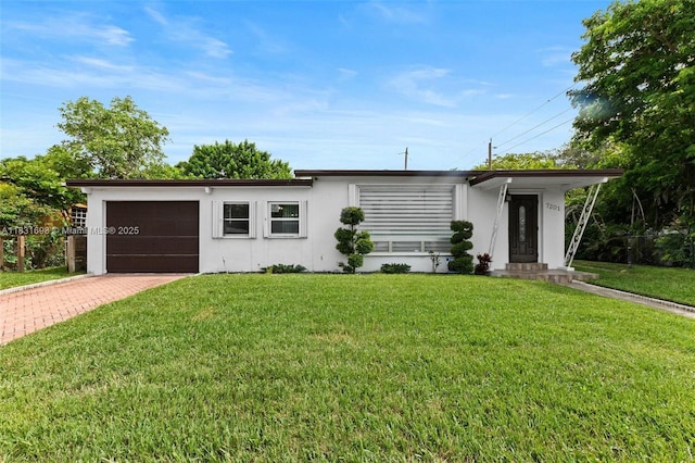 7201 Hayes St, Hollywood, FL 33024 - view of front facade featuring an attached garage, decorative driveway, stucco siding, and a front lawn
