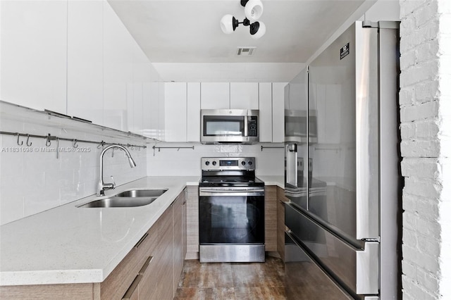 7201 Hayes St, Hollywood, FL 33024 - kitchen featuring appliances with stainless steel finishes, modern cabinets, decorative backsplash, white cabinetry, and dark wood-style flooring