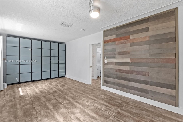 7201 Hayes St, Hollywood, FL 33024 - unfurnished room with a textured ceiling and wood finished floors