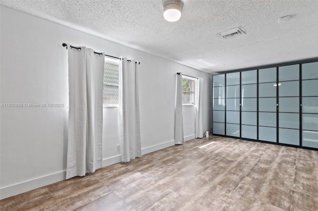 7201 Hayes St, Hollywood, FL 33024 - spare room featuring a textured ceiling and wood finished floors