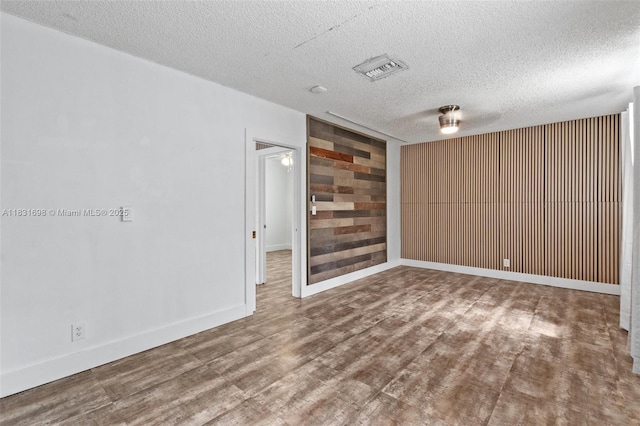 7201 Hayes St, Hollywood, FL 33024 - empty room with a textured ceiling, wood finished floors, and wooden walls