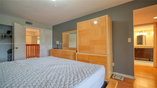 11101 SW 15th Mnr, Davie, FL 33324 - bedroom with light wood-type flooring and connected bathroom