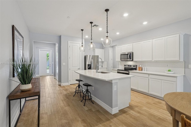 8367 NW 7th Pl Unit 0, Plantation, FL 33324 - kitchen featuring stainless steel appliances, a center island with sink, decorative backsplash, white cabinets, and recessed lighting