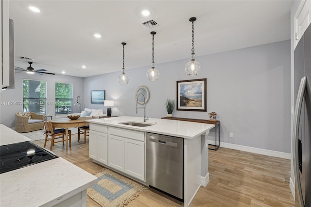 8367 NW 7th Pl Unit 0, Plantation, FL 33324 - kitchen with appliances with stainless steel finishes, open floor plan, light wood-style flooring, white cabinetry, and hanging light fixtures