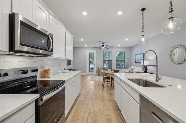 8367 NW 7th Pl Unit 0, Plantation, FL 33324 - kitchen featuring appliances with stainless steel finishes, recessed lighting, light wood-type flooring, backsplash, and white cabinetry