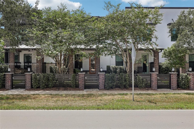 8367 NW 7th Pl Unit 0, Plantation, FL 33324 - obstructed view of property with brick siding, a fenced front yard, and a gate