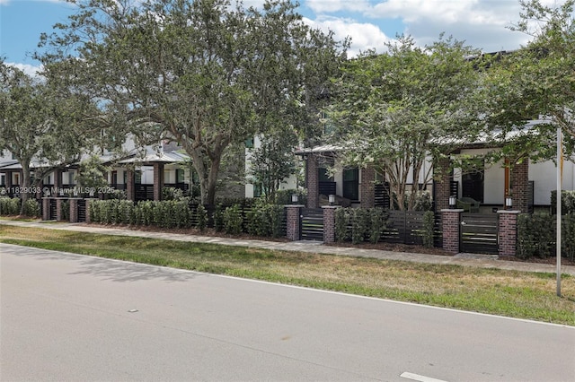 8367 NW 7th Pl Unit 0, Plantation, FL 33324 - view of property hidden behind natural elements with a fenced front yard and brick siding