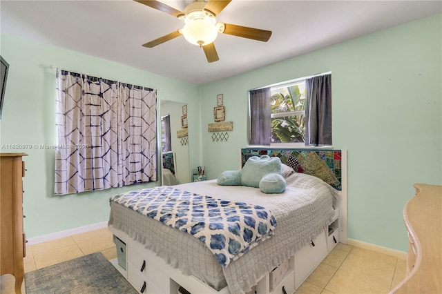 1884 Juno Rd, North Palm Beach, FL 33408 - bedroom with light tile patterned floors and a ceiling fan