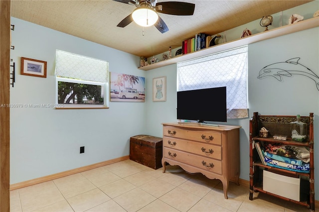 1884 Juno Rd, North Palm Beach, FL 33408 - bedroom with light tile patterned flooring and ceiling fan