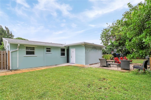 1884 Juno Rd, North Palm Beach, FL 33408 - back of property with a patio and stucco siding