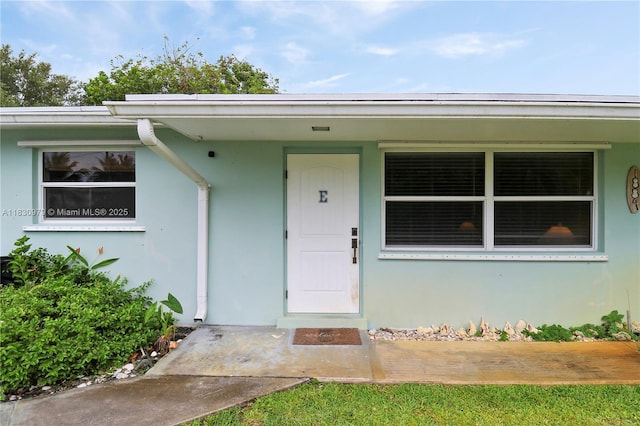 1884 Juno Rd, North Palm Beach, FL 33408 - doorway to property featuring stucco siding