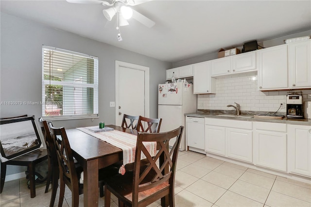 1884 Juno Rd, North Palm Beach, FL 33408 - kitchen featuring white appliances, a ceiling fan, light tile patterned flooring, and backsplash
