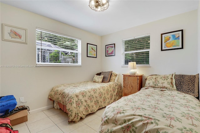 1884 Juno Rd, North Palm Beach, FL 33408 - bedroom with light tile patterned floors and baseboards