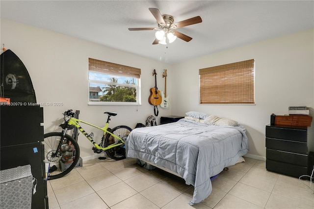 1884 Juno Rd, North Palm Beach, FL 33408 - bedroom with light tile patterned floors and a ceiling fan