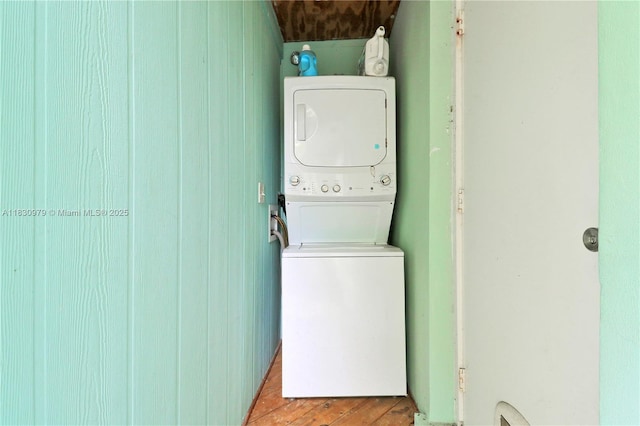 1884 Juno Rd, North Palm Beach, FL 33408 - laundry room featuring stacked washing machine and dryer and light wood-style floors